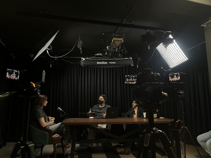 Multi-camera podcast shoot in progress, monitors live
